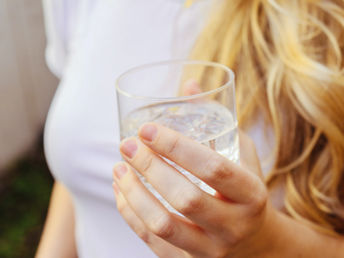 Girl holding a glass of water
