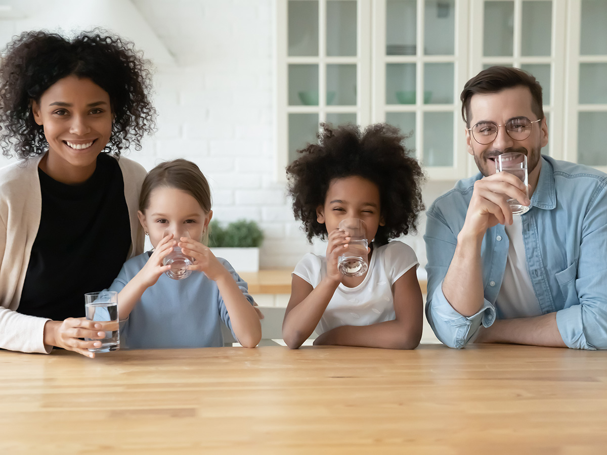 A happy family drinking glasses of water